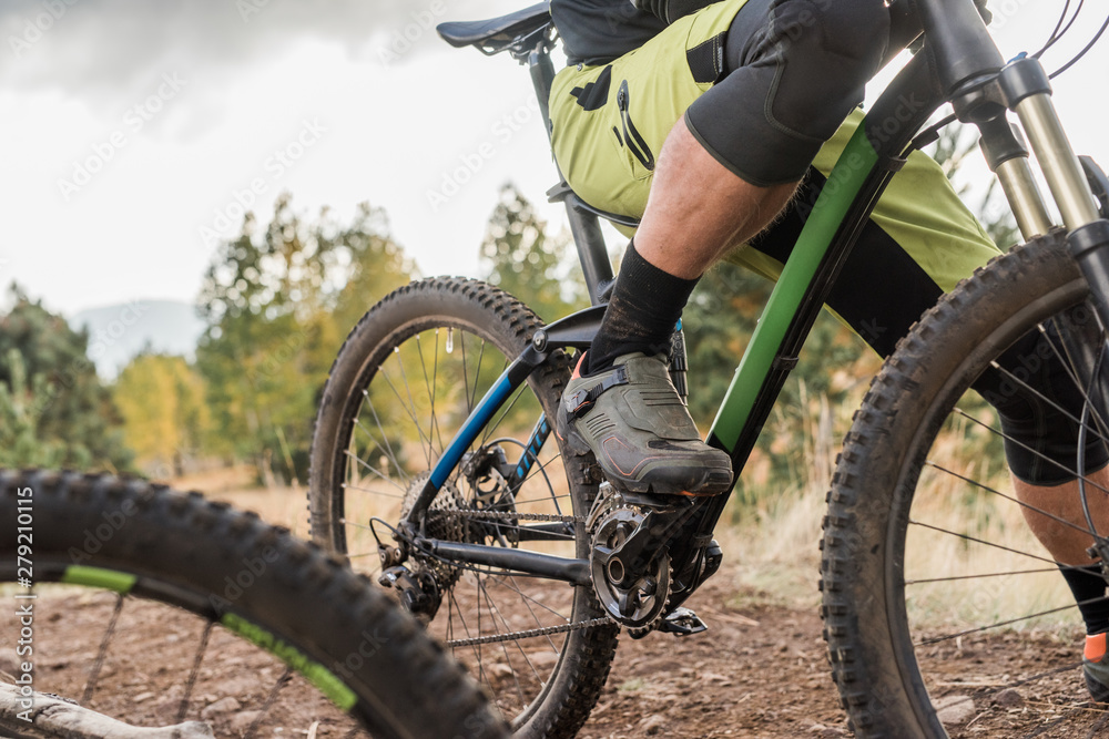 Closeup of mountain bikers shoes and bike Closeup of mountain bikers shoes and bike