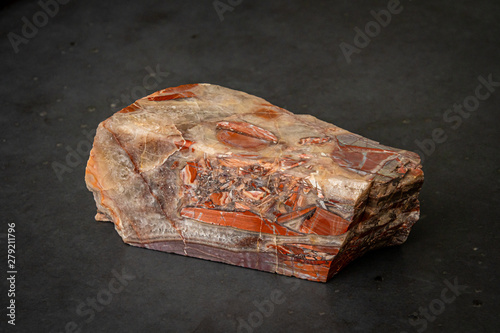 Red gemstone with colorful structure in many tones formed under high pressure photo