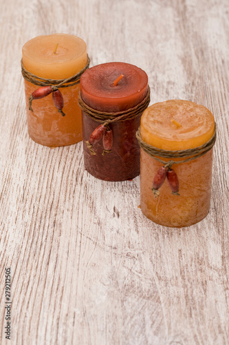 Romantic and scented candles on old wooden background