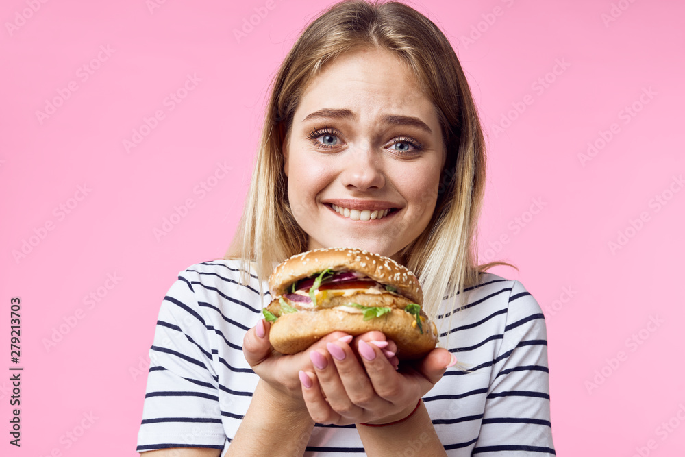 woman with hamburger and french fries woman with hamburger and french fries