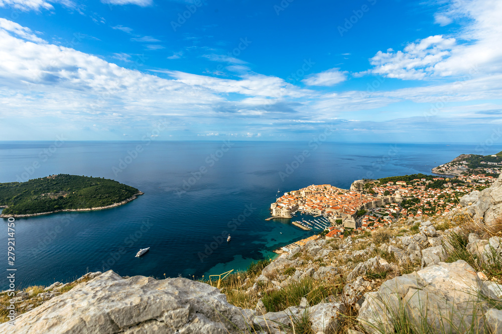 Fototapeta premium Beautiful townscape of Dubrovnik city and Lokrum island in Croatia, panorama view. Old town and blue bay with boats