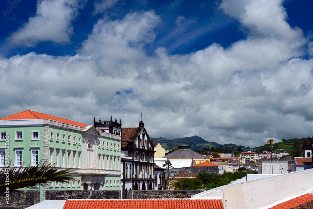 Beautiful white clouds against the blue sky. The beautiful city of Ponta Delgada on the island of San Miguel, Azores, Portugal. Travel to the Azores.