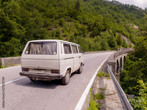 old white van on asphalt road in beautiful countryside