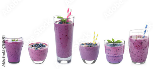 Glasses of delicious blueberry smoothie on white background