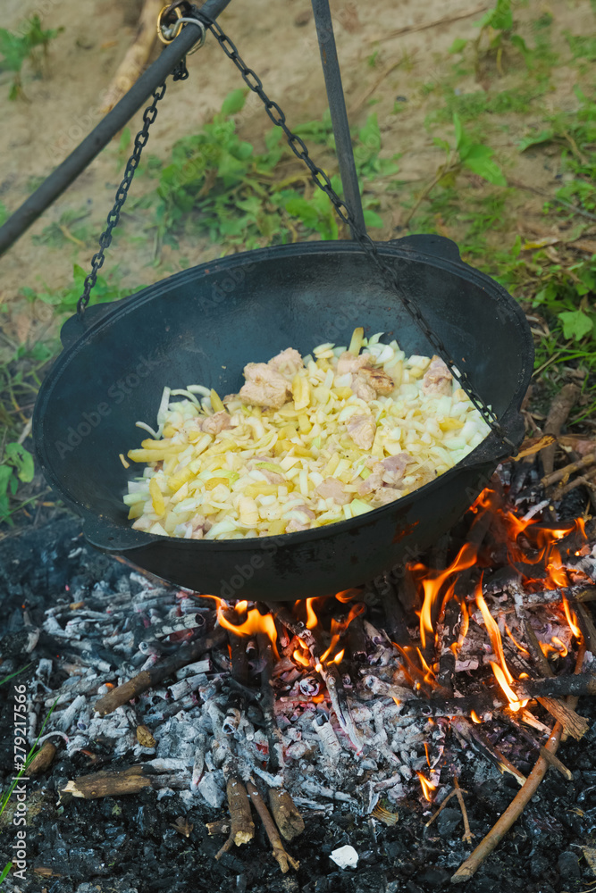 heating kettle with food on fire. beginning cooking heating kettle with food on fire. beginning cooking