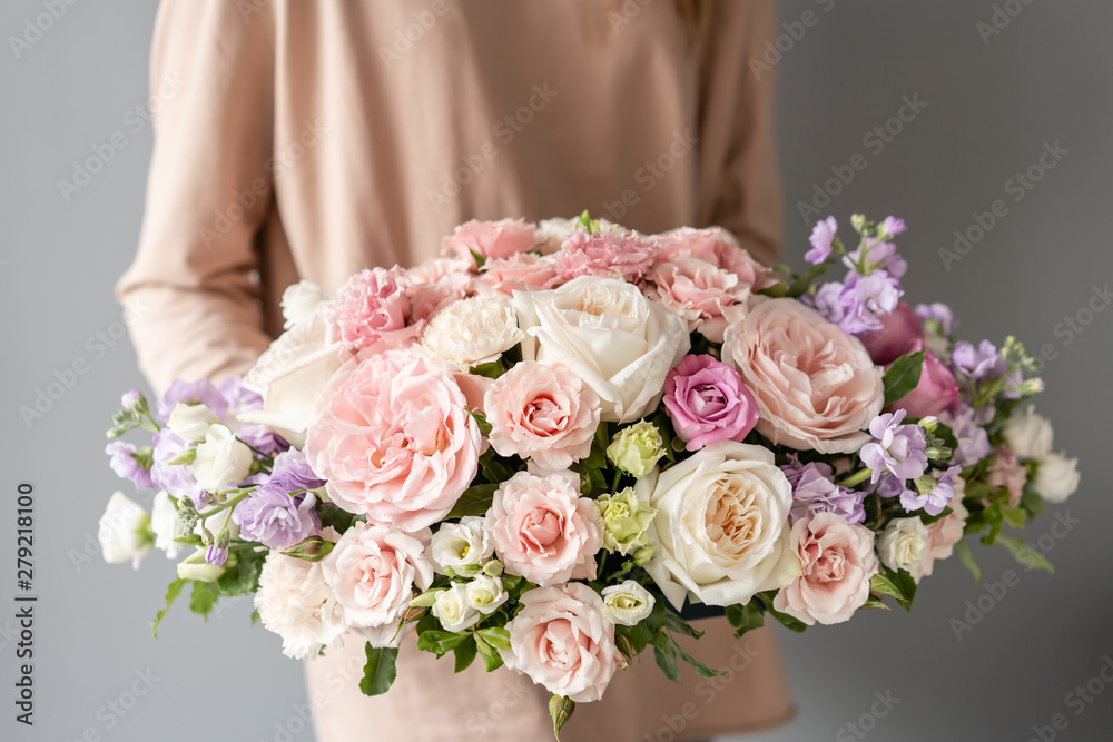 Beautiful bouquet of mixed flowers in woman hand. Floral shop concept . Handsome fresh bouquet. Flowers delivery Beautiful bouquet of mixed flowers in woman hand. Floral shop concept . Handsome fresh bouquet. Flowers delivery