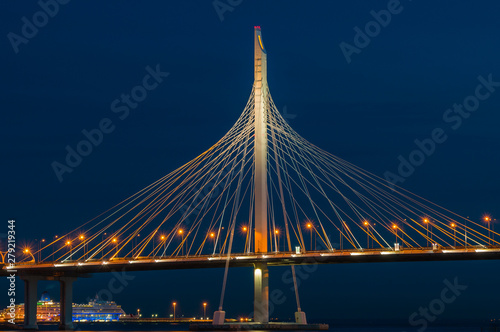 Bridge over the river at night on long exposure. Fragment of Cable-stayed bridge across the Petrovsky fairway. Saint Petersburg, Russia.