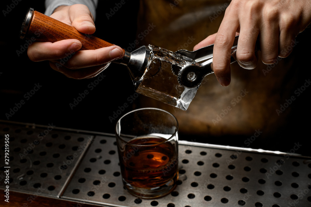 Bartender making a stamp imprint on the big ice cube
