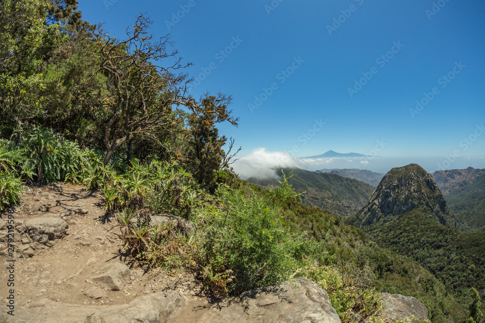 Los roques and famous Agando rock - cult place near Garajonay national park at La Gomera. Old volcanic mountain peaks. Thickets of relic laurels and heather on steep green slopes. Canary. Spain