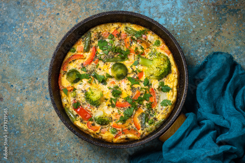 Frittata with fresh vegetables in the skillet.