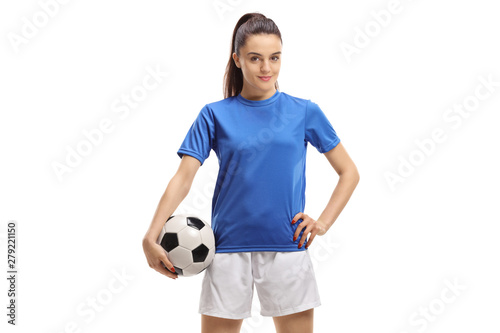 Female soccer player posing with a football