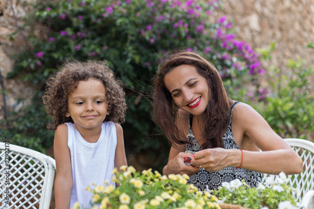 Happy family of mom and toddler son enjoyed in gardening activities Happy family of mom and toddler son enjoyed in gardening activities