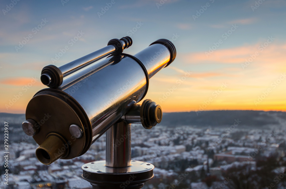 Monocular telescope in winter at sunset over Marburg, Germany Monocular telescope in winter at sunset over Marburg, Germany