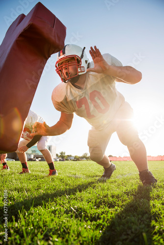 Photography Teenage football player (14-15, 16-17) practicing with team mates