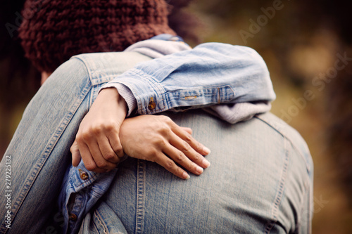 Fényképezés Hands of young woman embracing boyfriend