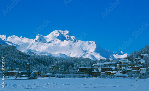 View from the frozen Lake St. Moritz to Piz Maloja in the Upper Engadin