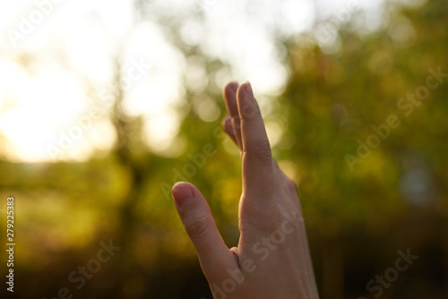 hand of man on green background of blue sky