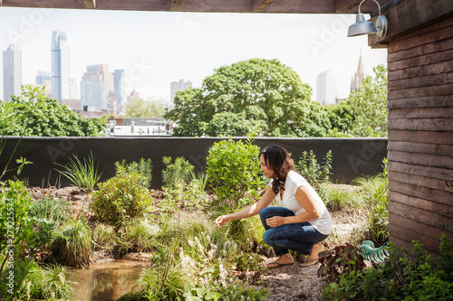 Woman planting plants in garden