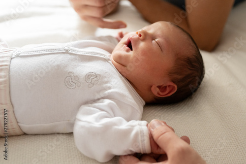 infant newborn baby dressed in white 