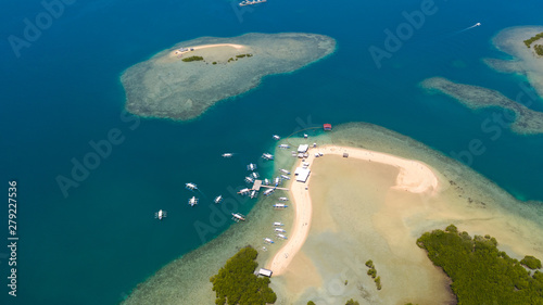 Luli island, Puerto Princesa, Palawan. Island hopping Tour at Honda Bay, Palawan. An island of white sand with mangroves. Atoll with a white island, view from above.