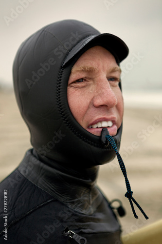 Photography Portrait of man wearing wetsuit on sandy beach