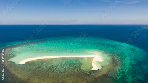 White sandy island with coral reefs.White sandbar.Atoll near the island of Camiguin, Philippines, aerial view.Seascape, white sand island