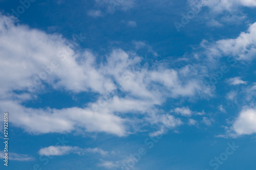 Blue sky in the soft white clouds. Natural cloudscape background, texture. Wide Horizontal Wallpaper With Copy Space