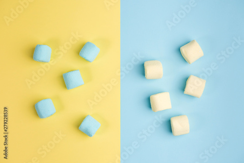 Marshmallow on blue and yellow backgrounds. Two colors. Top view.