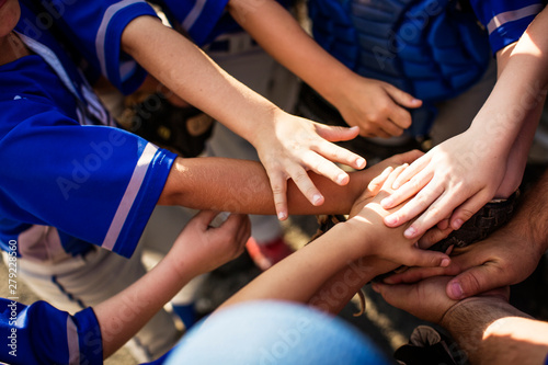 Canvas Print Baseball players stacking hands in huddle