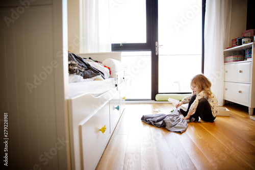 Girl (4-5) getting dressed