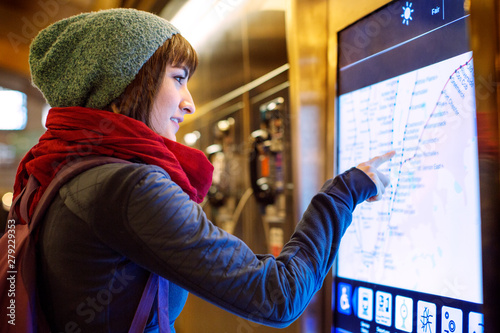 Photography Young woman checking subway map