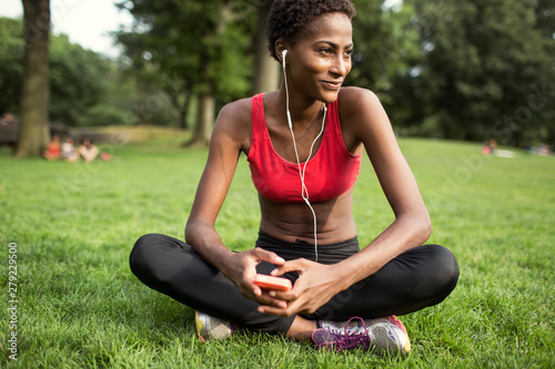 Photography Woman listening to music on smartphone while sitting in park