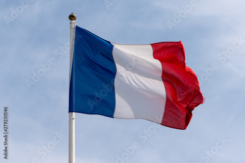 Fototapeta french flag of France waving over cloudy blue sky blue white red colors
