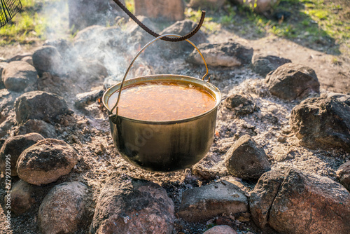 Big pot of hot soup. Cooking dinner on an open fire.