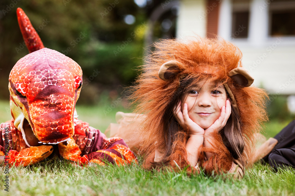 Naklejka premium Children in costumes lying on grass