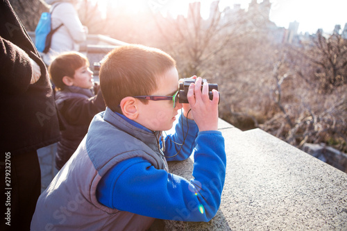 Boys (6-7, 8-9) looking through binoculars