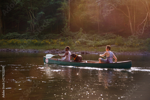 Friends canoeing in river