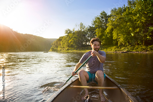 Photography Young man canoeing in river