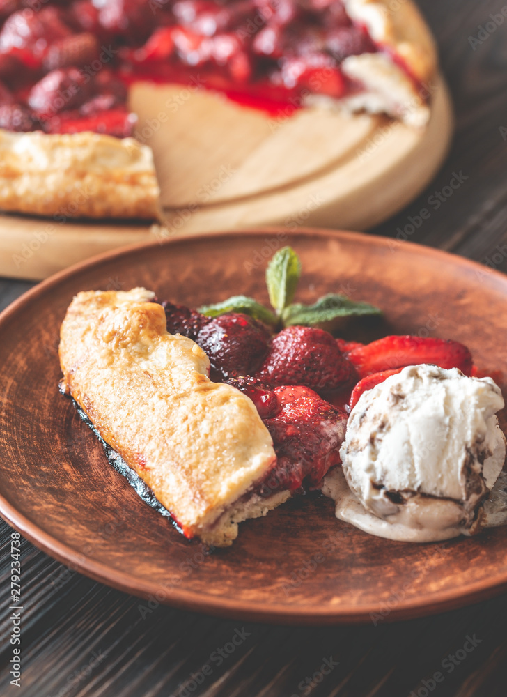 Slice of strawberry galette with ice-cream