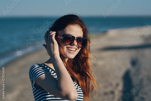 young woman in sunglasses on the beach