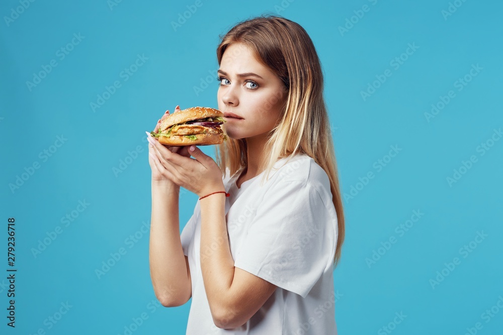 woman with hamburger and french fries woman with hamburger and french fries