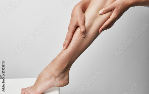 woman applying cream on her legs © SHOTPRIME STUDIO
