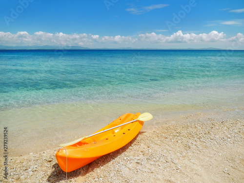Sea kayak with a paddle on the beach photo
