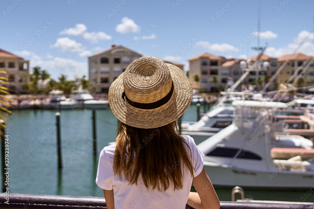 woman in hat on balcony