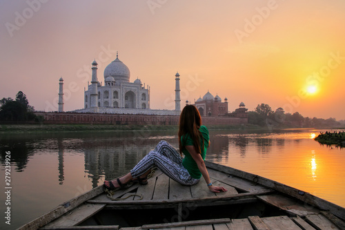 Woman watching sunset over Taj Mahal from a boat, Agra, India photo