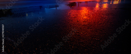 Background of wet asphalt with neon light. Blurred background  night lights  reflection. Night city  dark street.