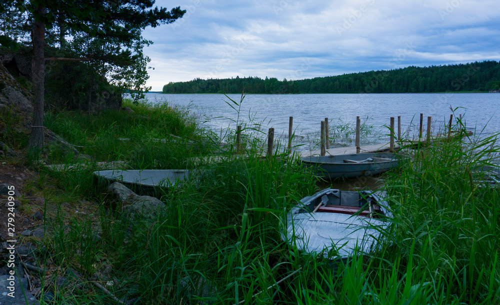 Evening twilight lake with boats and pier Evening twilight lake with boats and pier