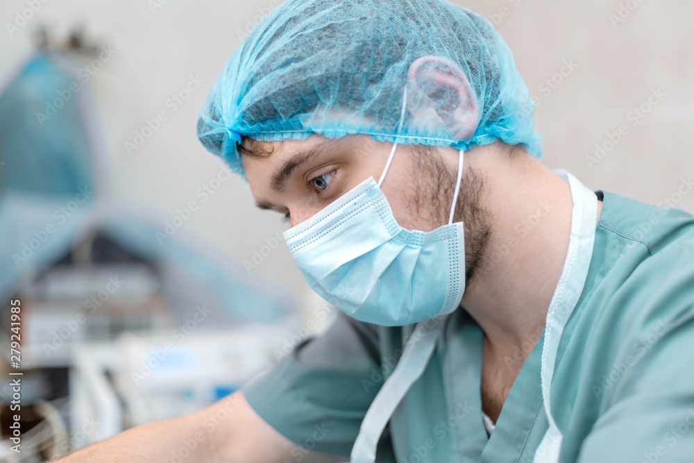 Portrait of professional surgeon focused on working process Portrait of professional surgeon focused on working process