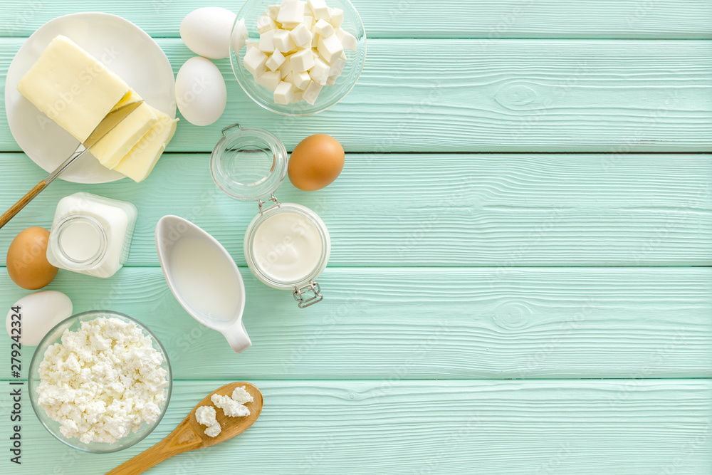 Breakfast on farm with dairy products on mint green wooden background top view space for text