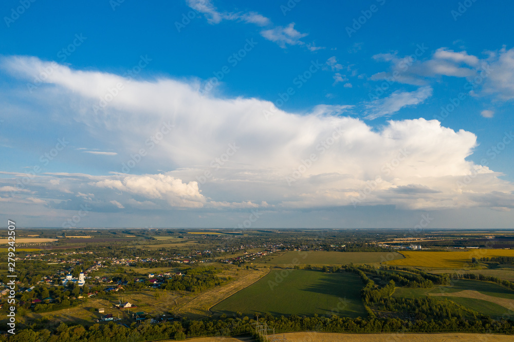Aerial panorama of countryside summer green meadows and blue sky with clouds, beautiful rural fields